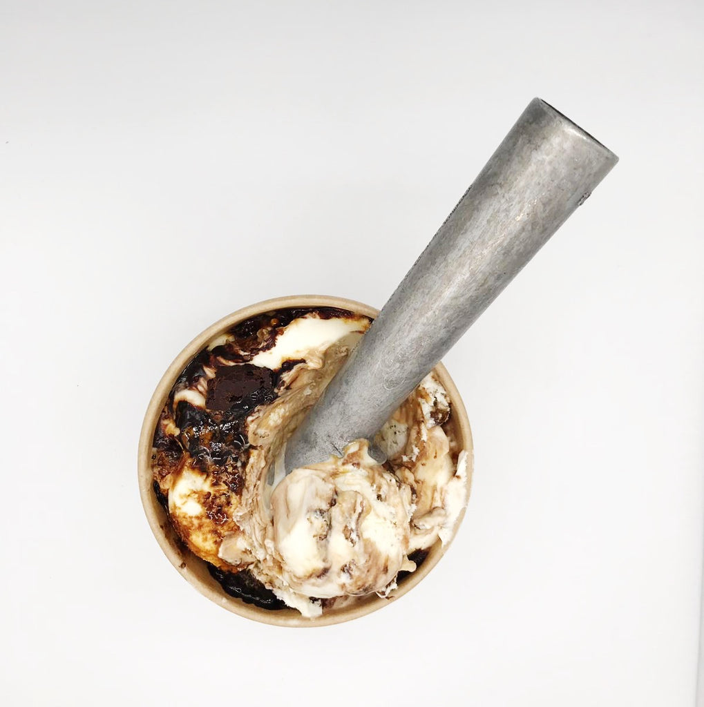 Brownie, Honeycomb, Caramel & Choccy Sauce Ice Cream in a tub with scoop